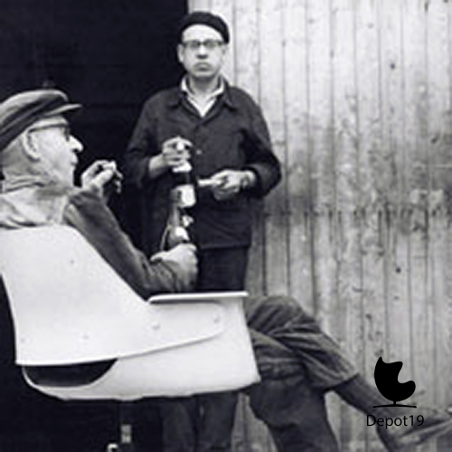 Lunch_break_in_the_workshop_with_bread_and_beer_and_a_prototype_of_the_240_model_1954.jpg